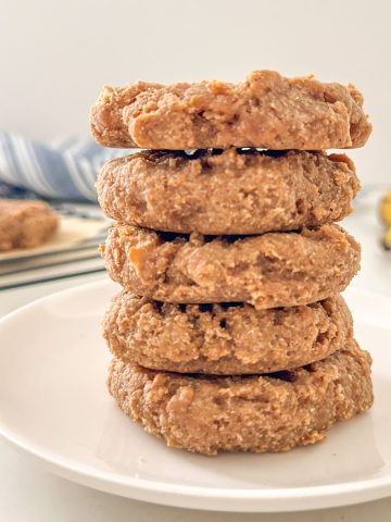 Stack of five vegan protein cookies on plate.