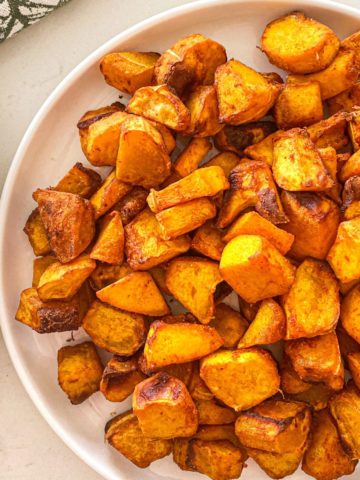 Air fried squash cubes in white dish.