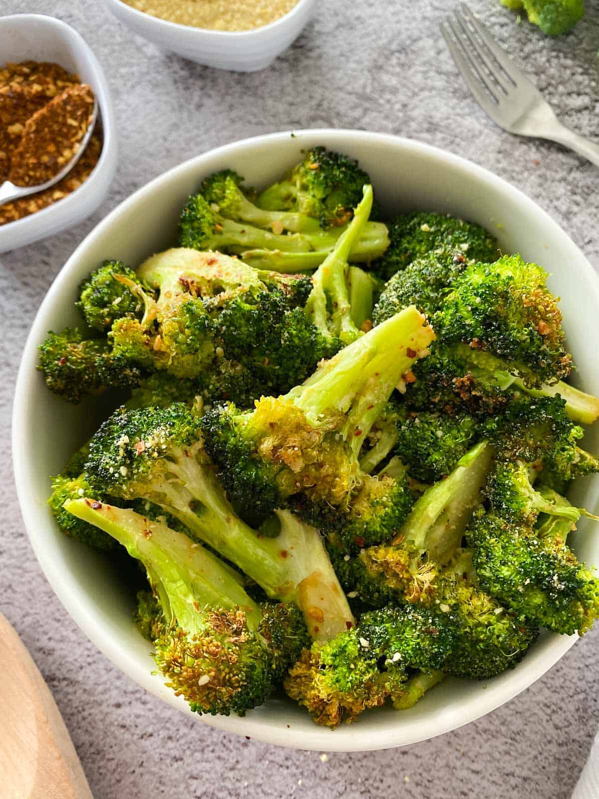 close up of bowl full of air fried broccoli