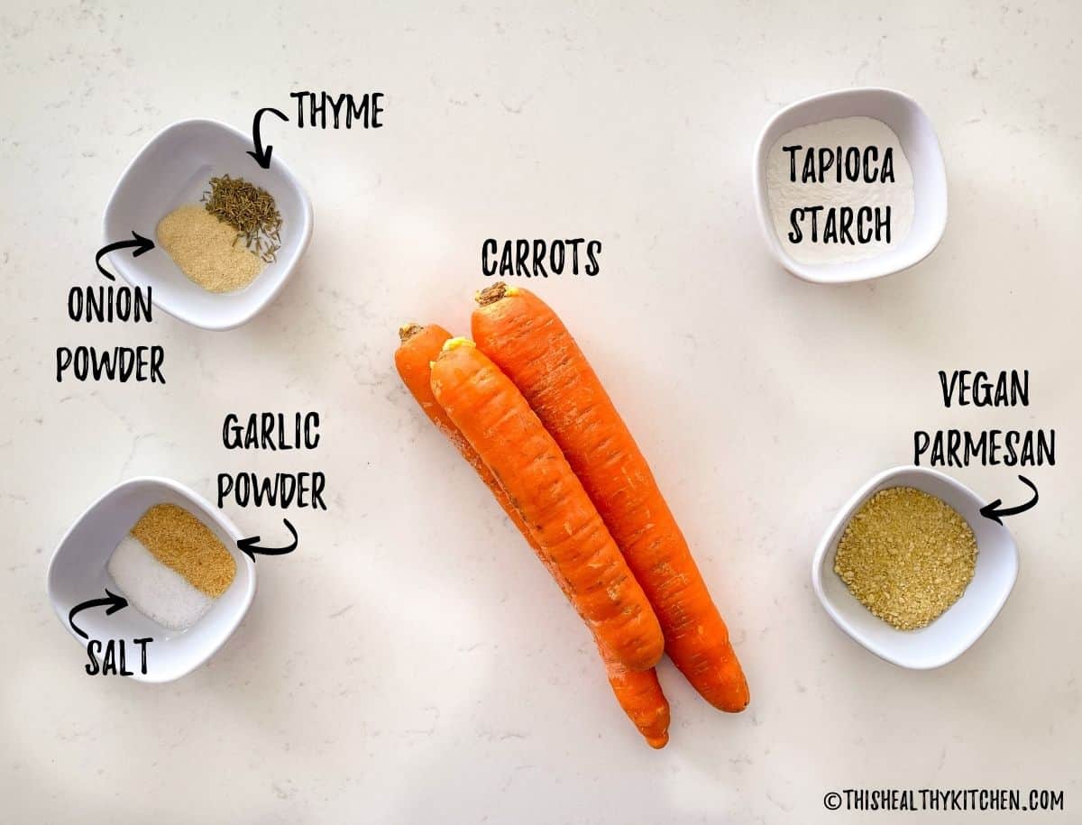 Carrots and spices scattered on kitchen counter top.
