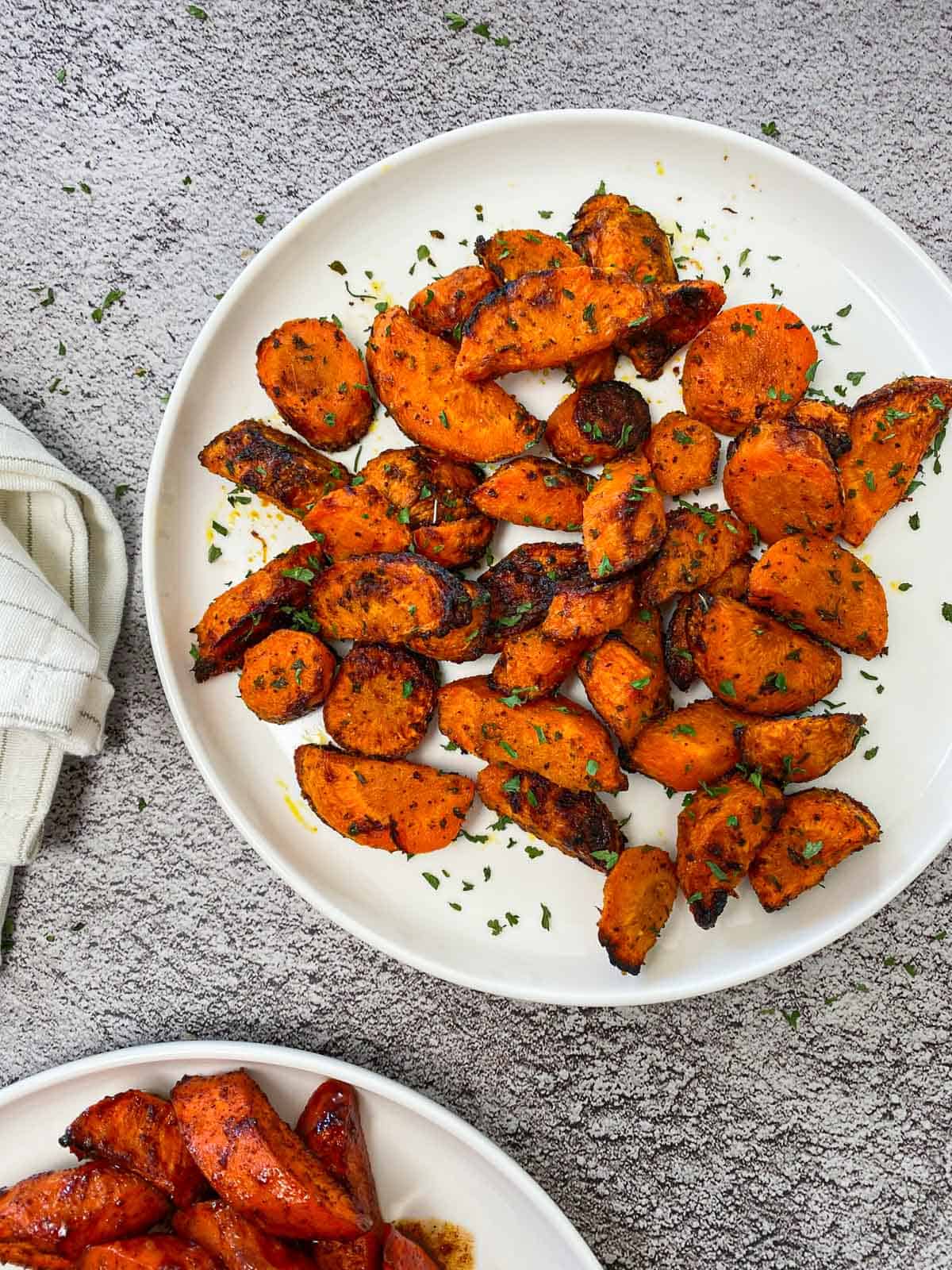 air fryer carrots with spicy seasoning resting in a white dish