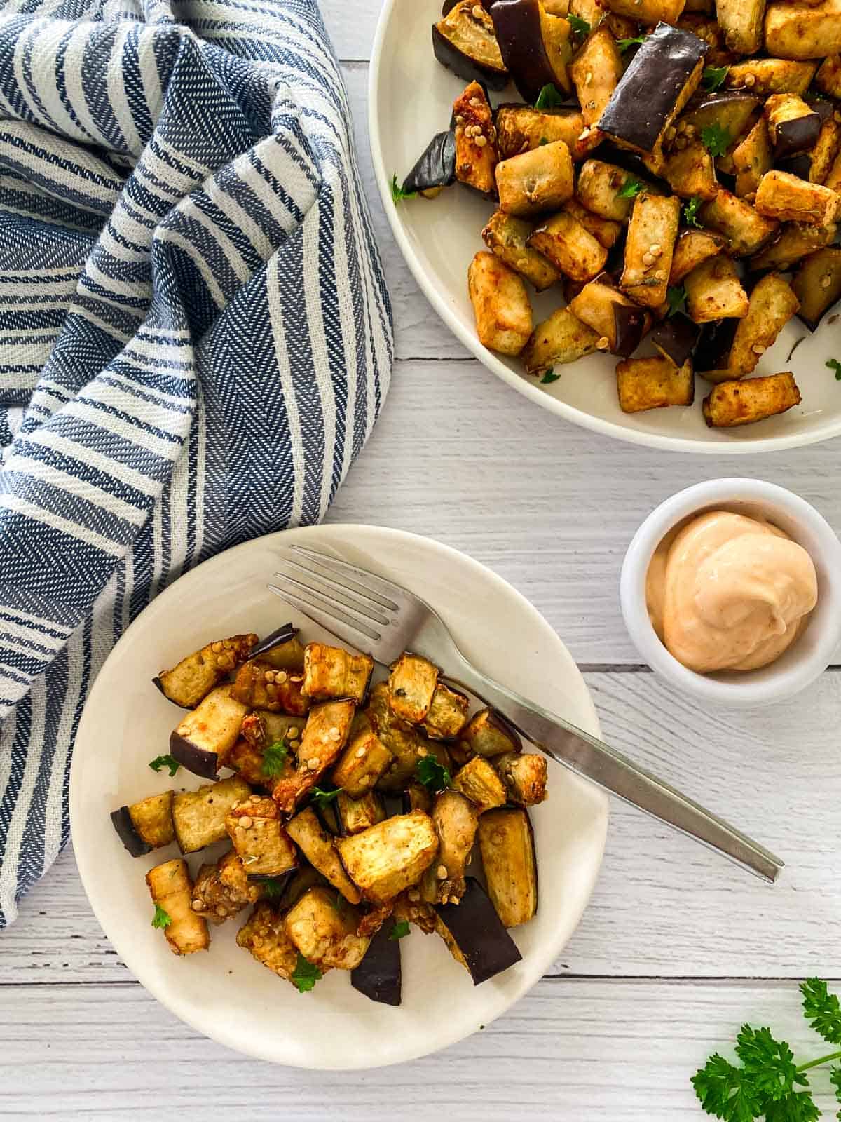 Small plate with cubed air fried eggplant and dipping sauce above.