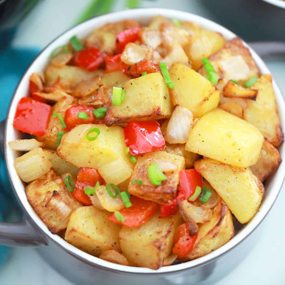 Air fried home fries inside purple serving bowl.