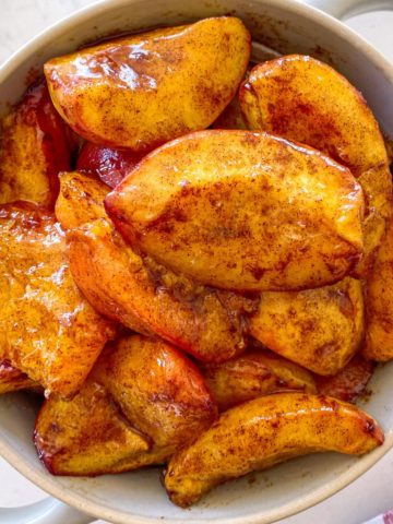 Air fried peach slices in serving bowl.