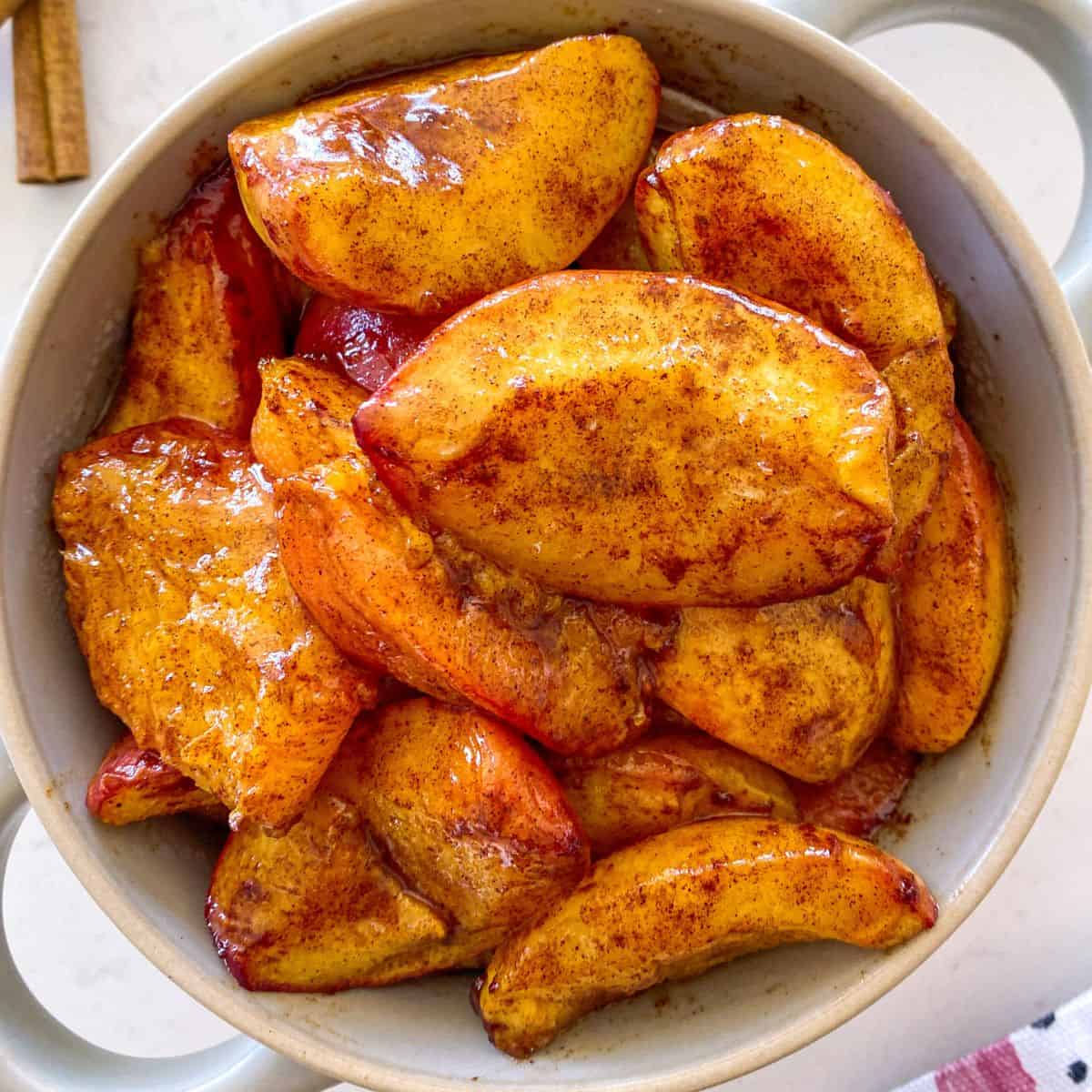 Air fried peach slices in serving bowl.