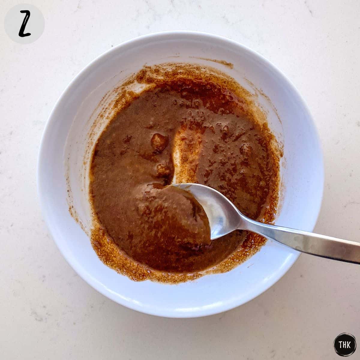 Brown sugary mixture in white bowl.
