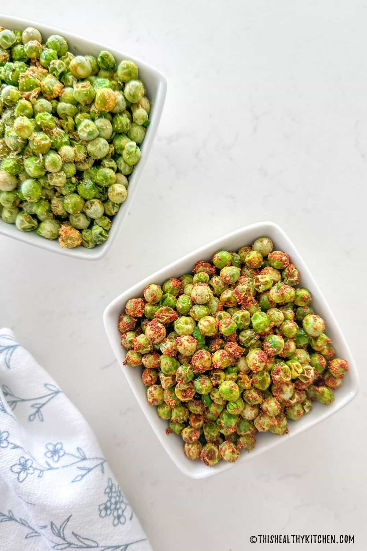 Two small bowls of seasoned air fried peas.