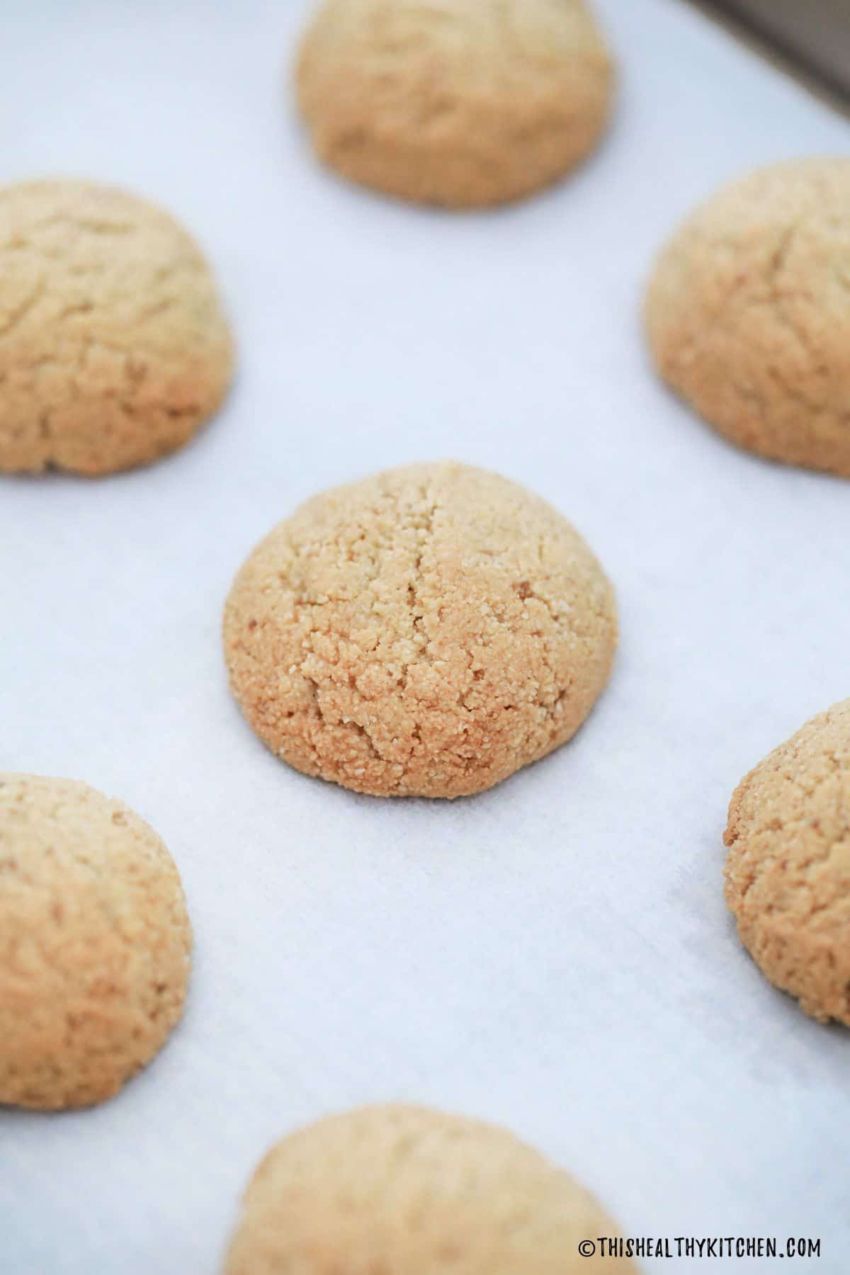 White cookies on baking tray after baking.