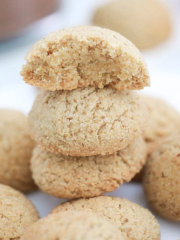 Almond flour cookies in a stack with top one cut in half.