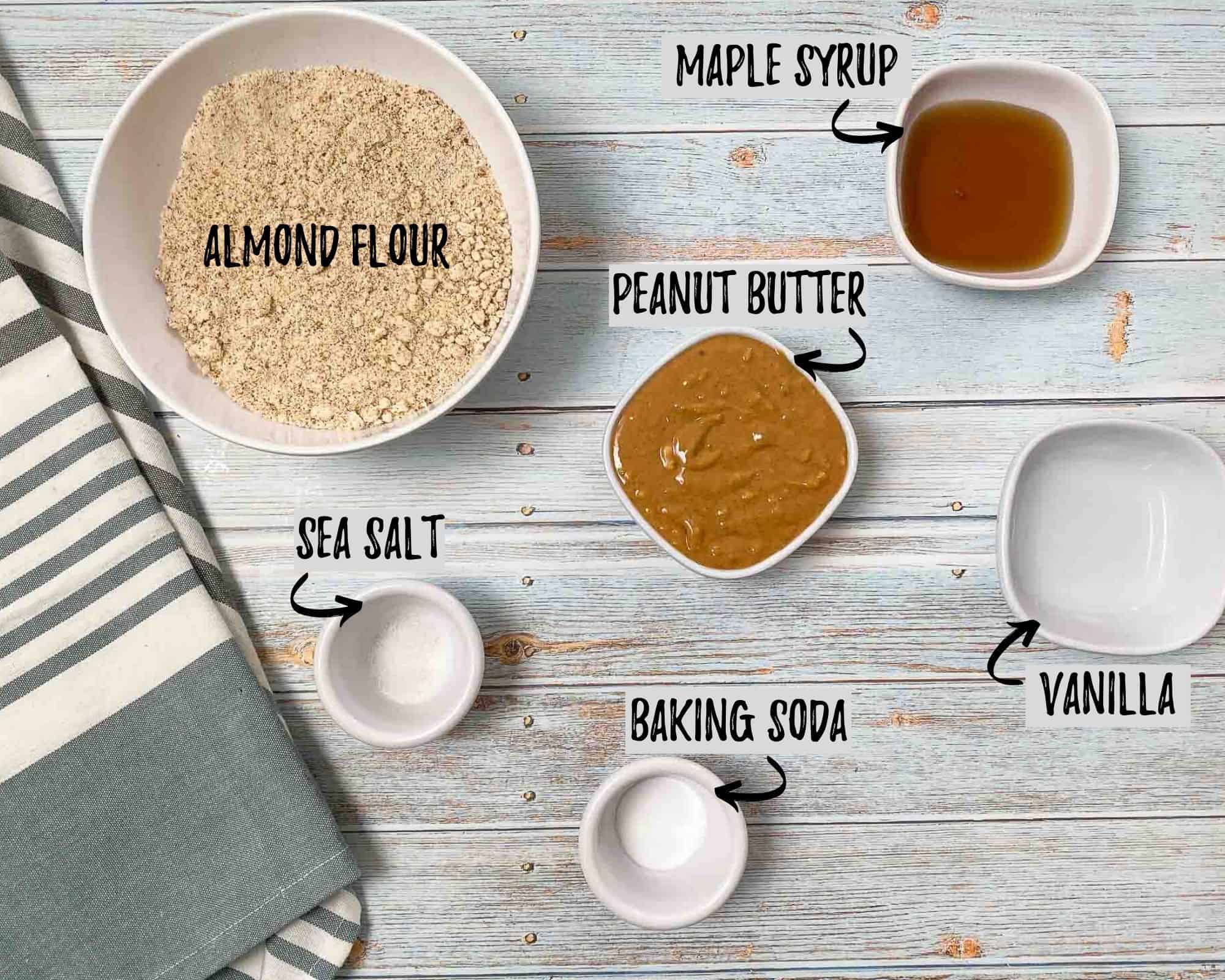 bowl of flour, bowl of peanut butter, bowl of maple syrup, cup of vailla, cup of salt and baking soda