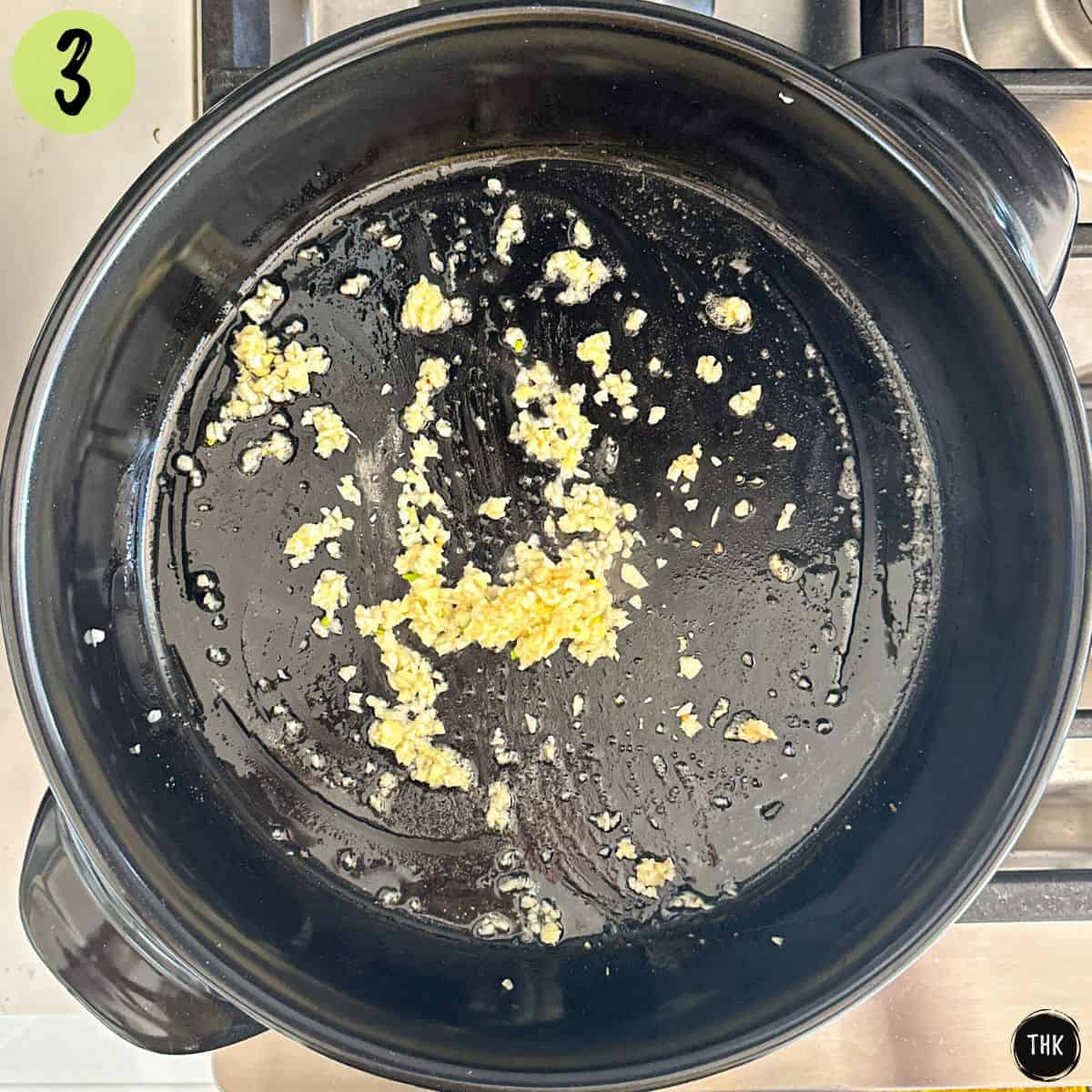Sautéed garlic in large black skillet.