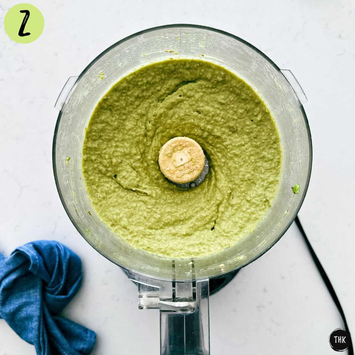 Smooth green dip inside food processor bowl.