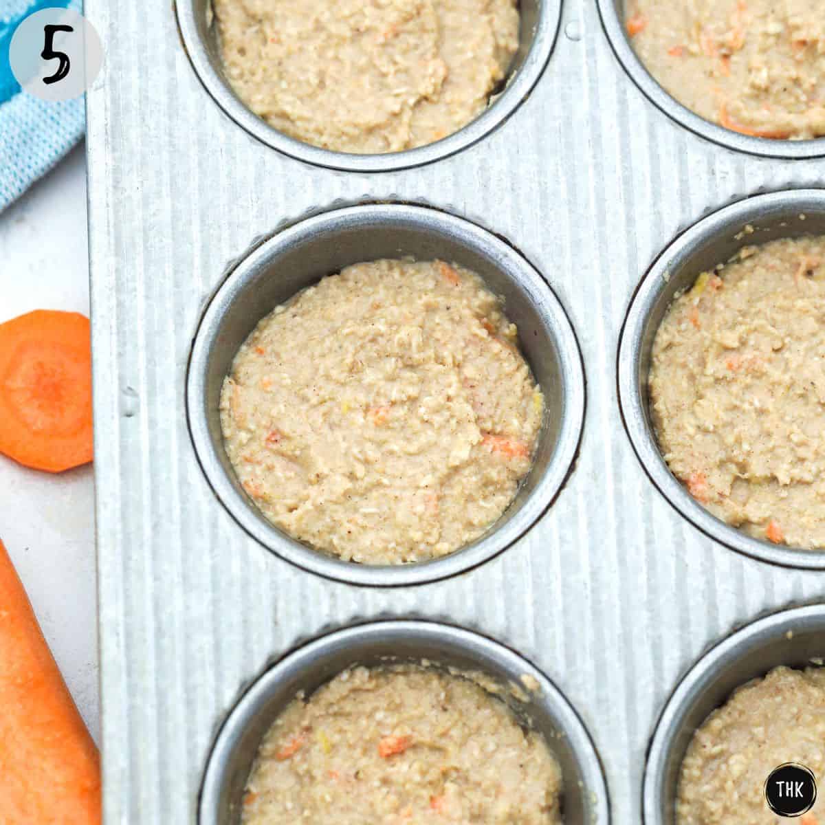 Muffin batter inside muffin tin.