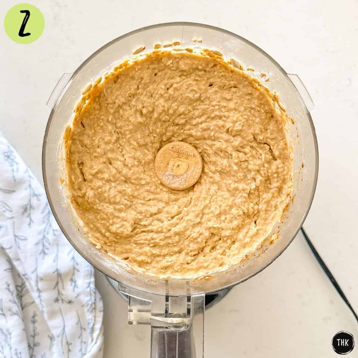 Banana muffin batter inside food processor bowl.
