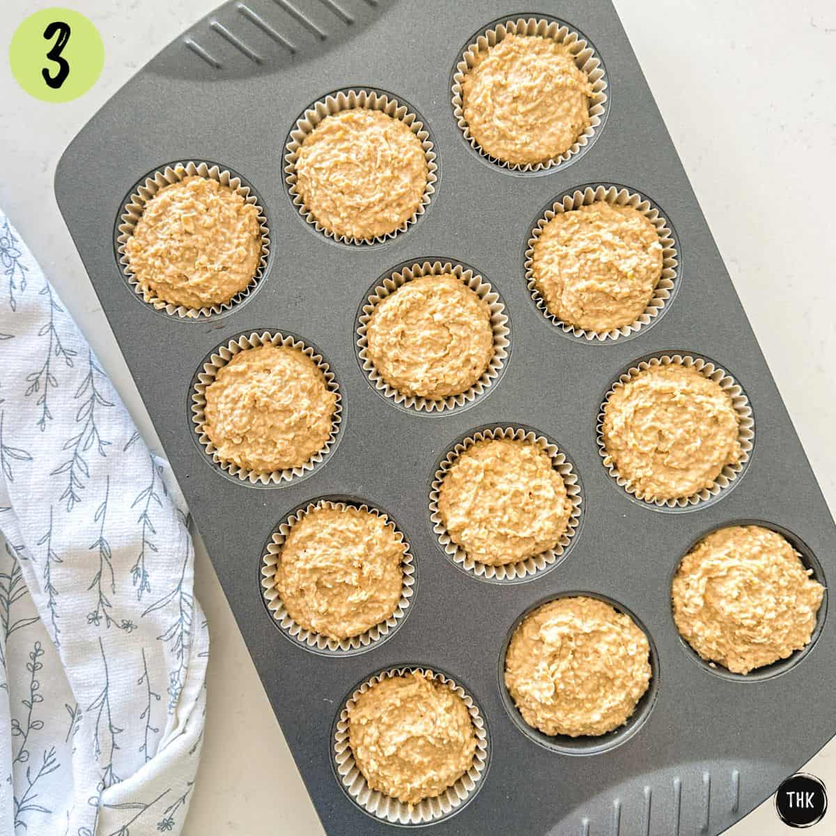 Banana muffin batter inside muffin tins before baking.