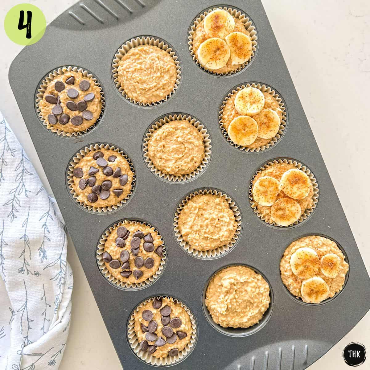 Chickpea banana muffin batter in muffin pan, some topped with banana slices or chocolate chips.