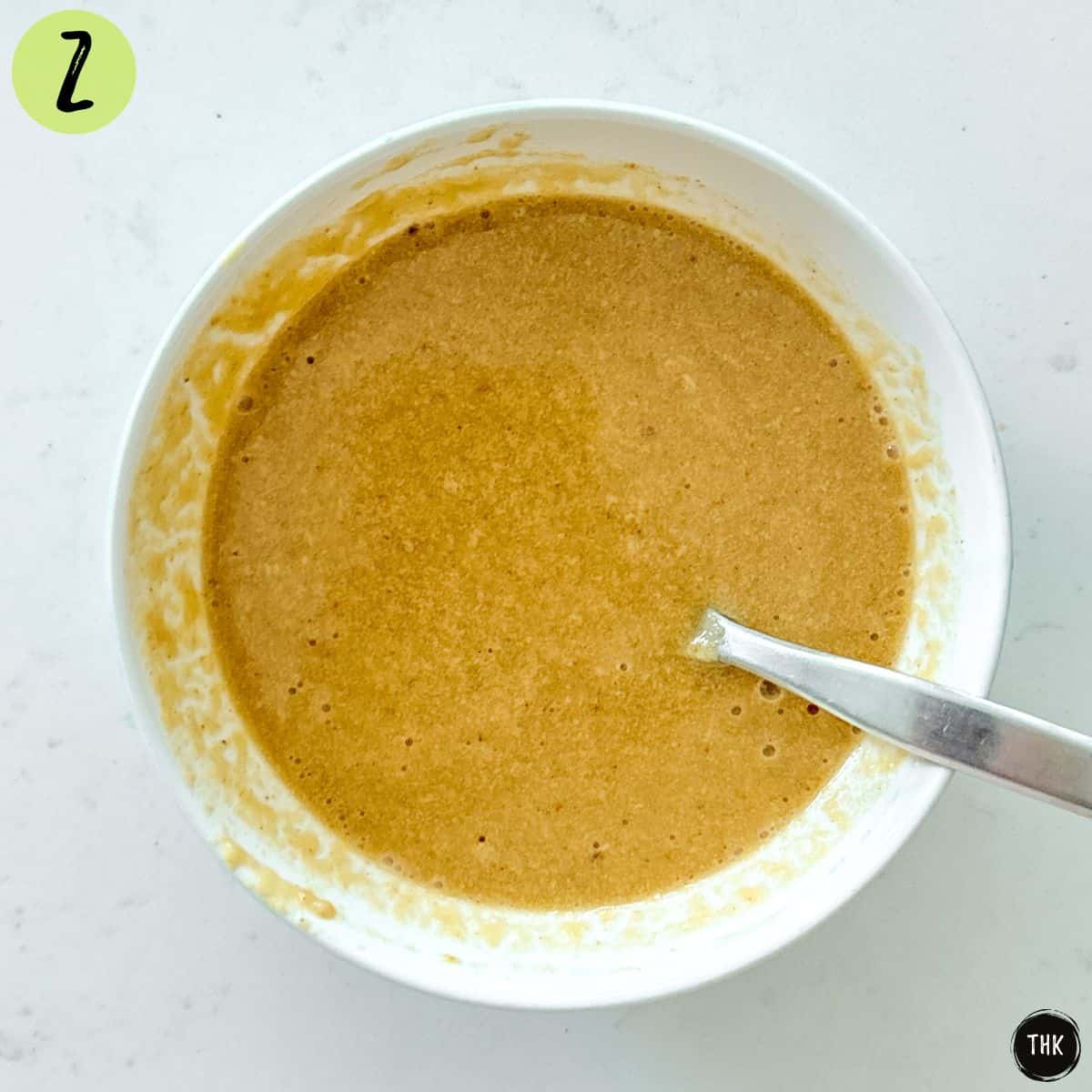 Small bowl of tahini based salad dressing.