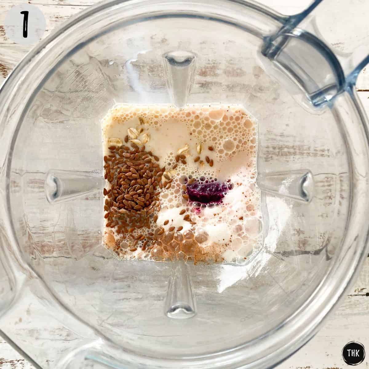 Blender with milk, flax seeds, beets, oats, and cinnamon inside.