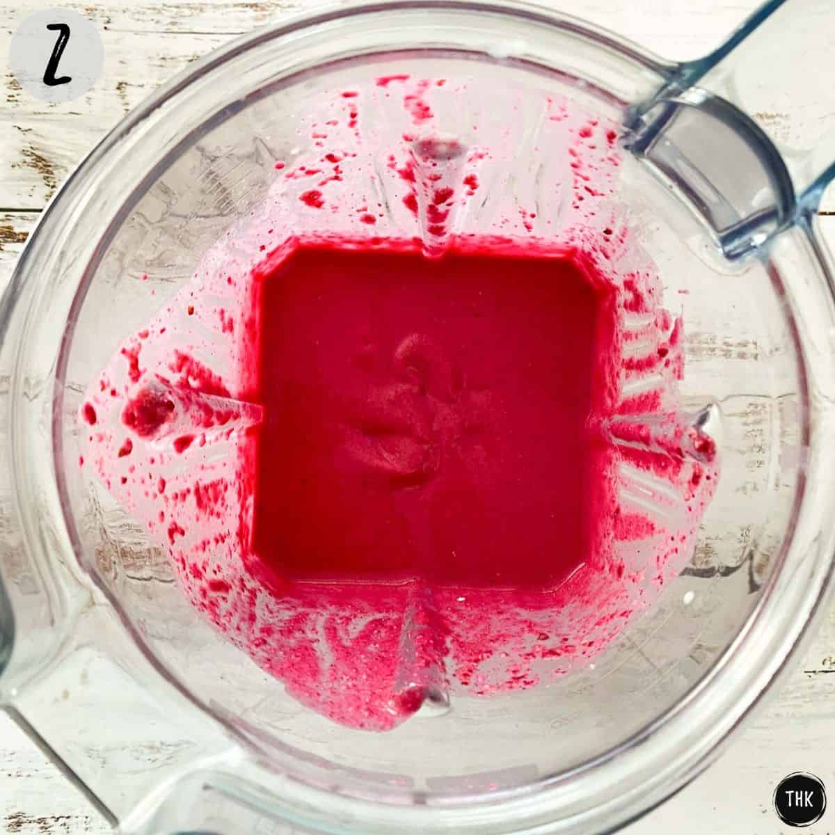 Pink pancake batter inside blender.
