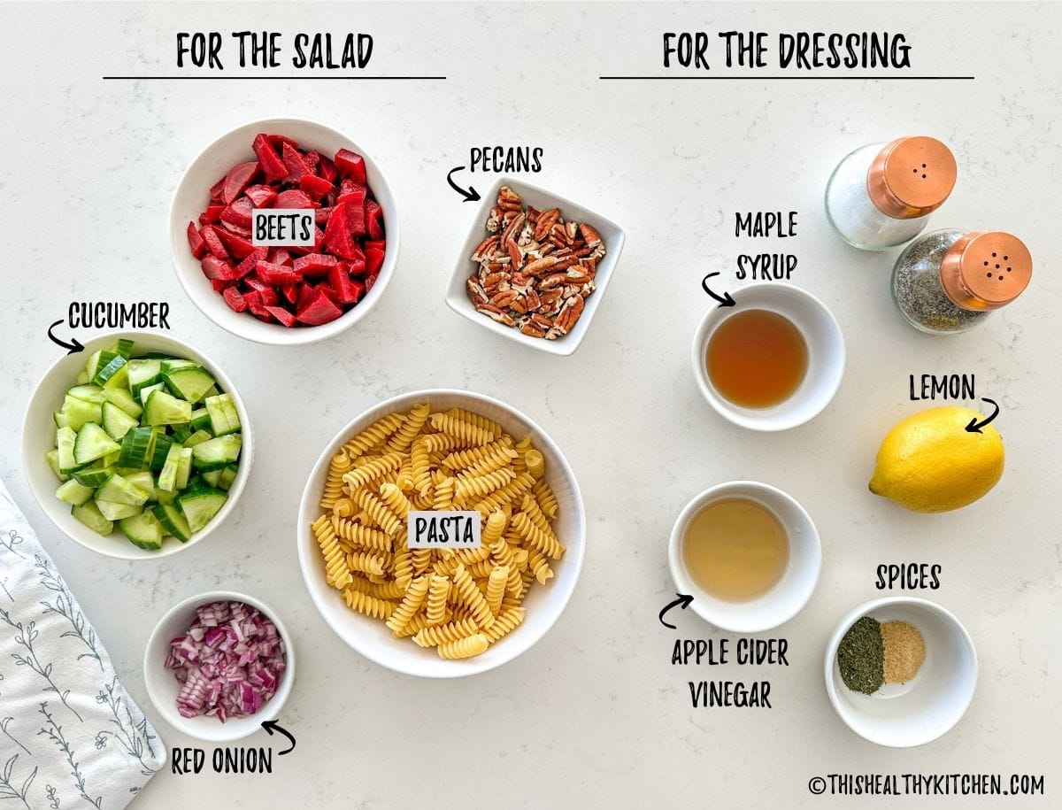 Ingredients to make beet pasta salad in prep bowls on kitchen countertop.