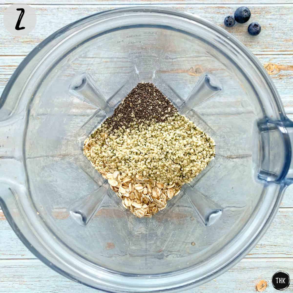 Blender with oats and seeds inside.