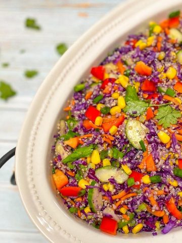Serving dish with purple cabbage salad inside.