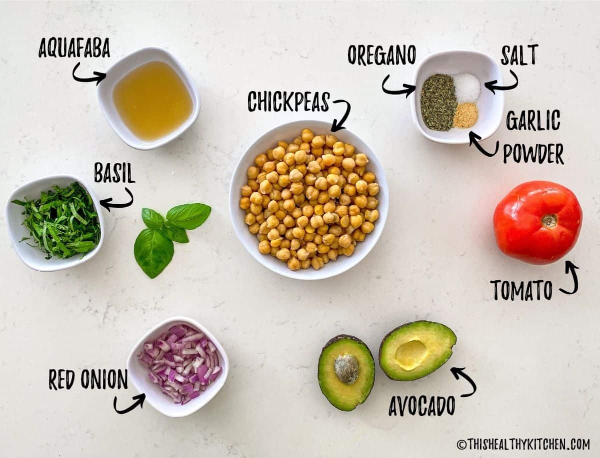 Ingredients to make chickpea salad scattered on kitchen counter top.