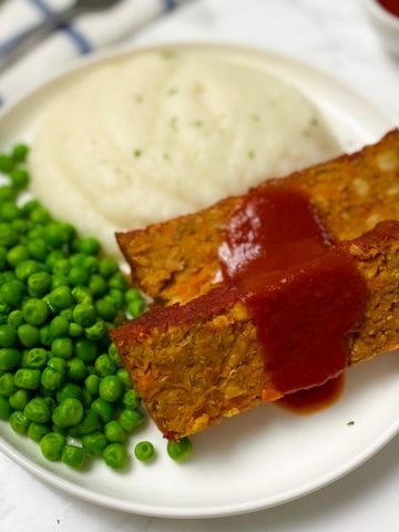 sliced vegan loaf with red sauce glazed on top