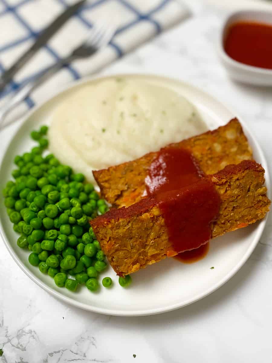 sliced vegan loaf with red sauce glazed on top