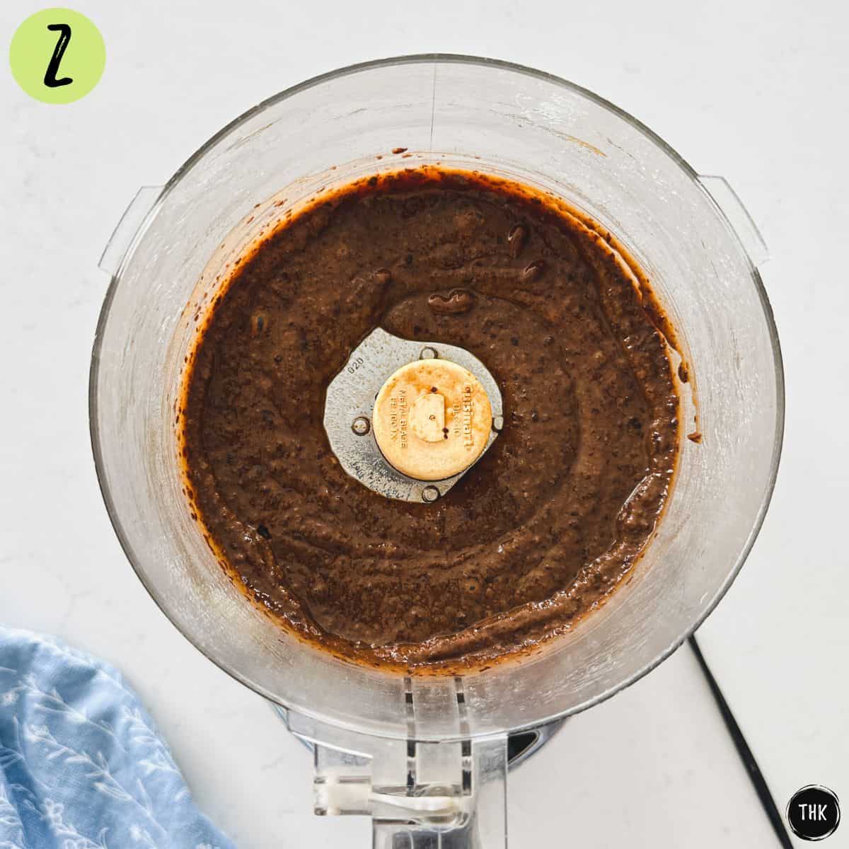 Blended black bean chocolate cake inside food processor.