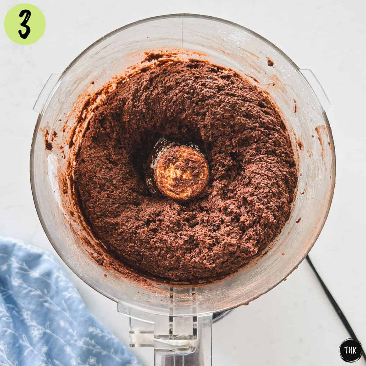 Black bean chocolate cake batter inside food processor bowl.