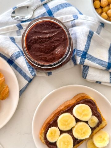 Jar of nut-free nutella with toast and chickpeas beside it.