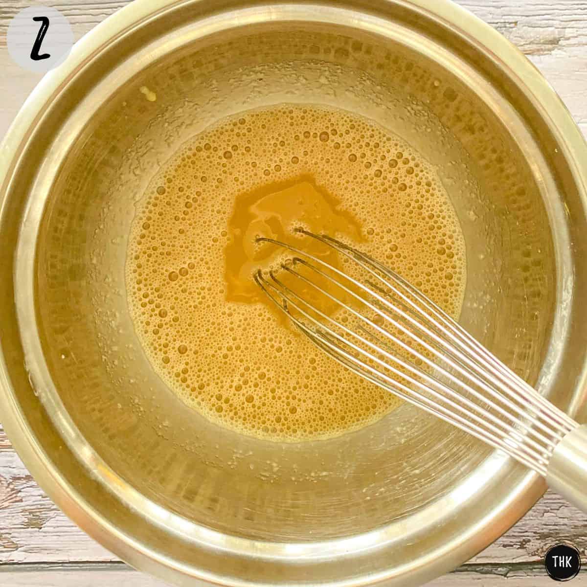 Mixing bowl with a liquid mixture inside.