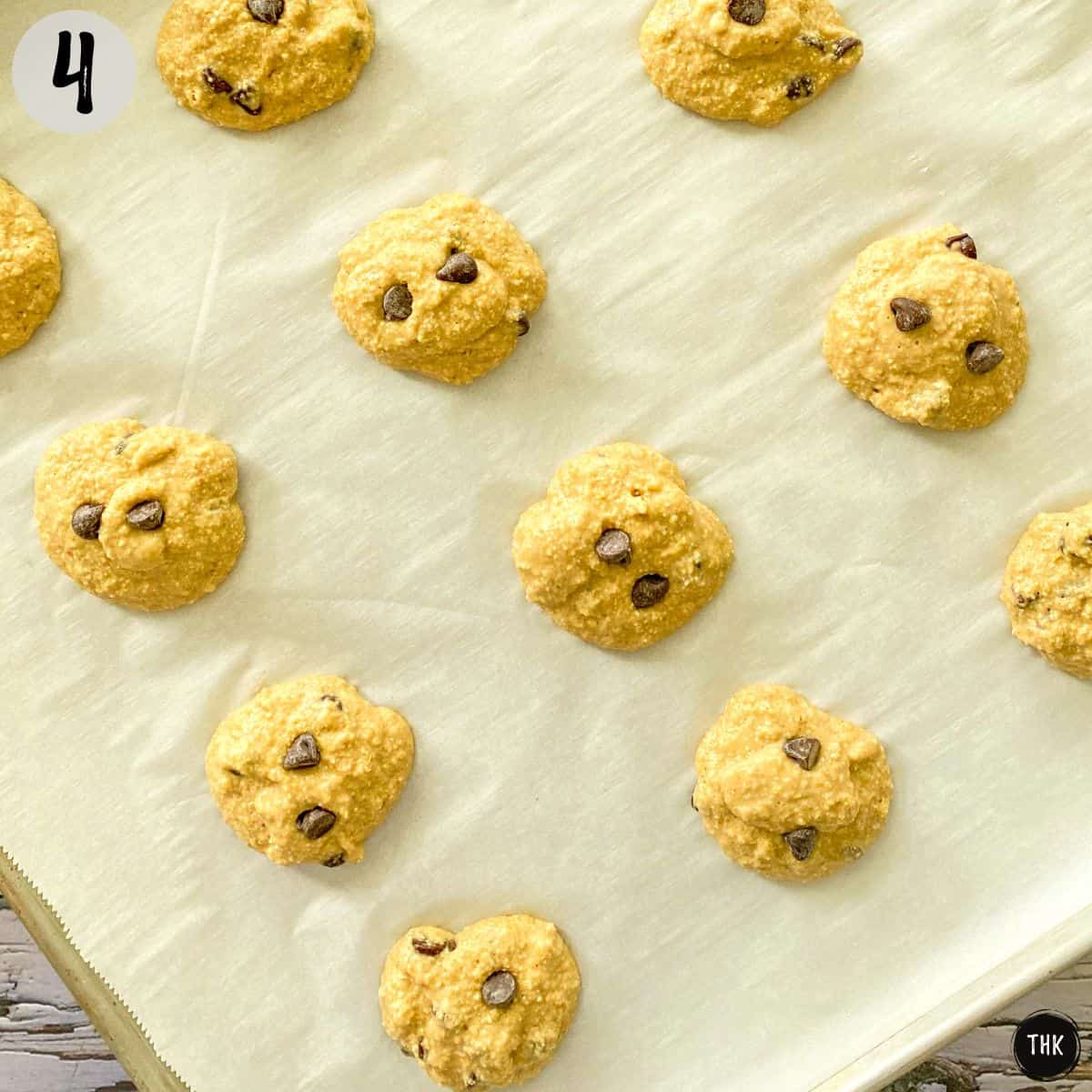 Chocolate chip cookies on baking sheet before baking.