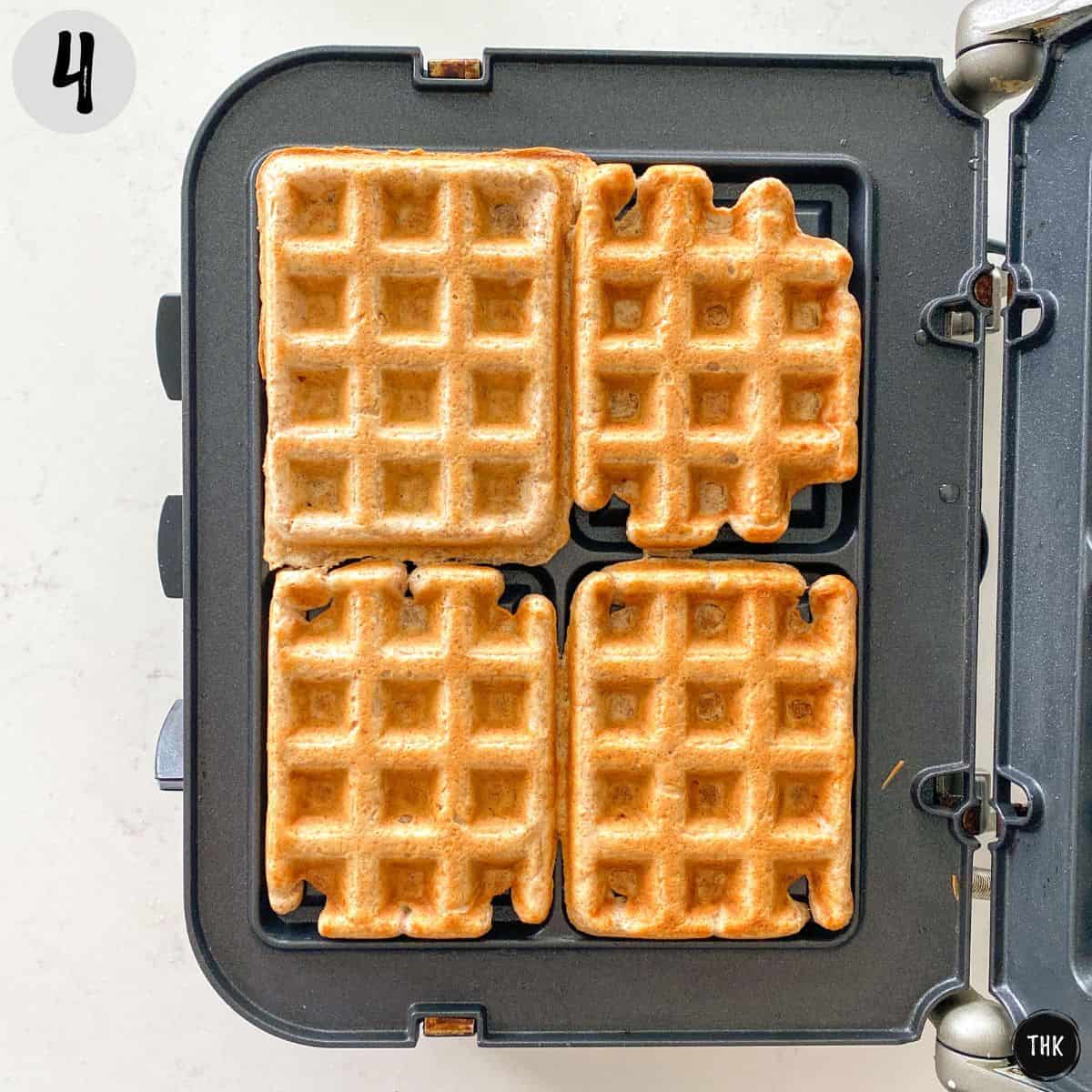 Cooked waffles on waffle iron.