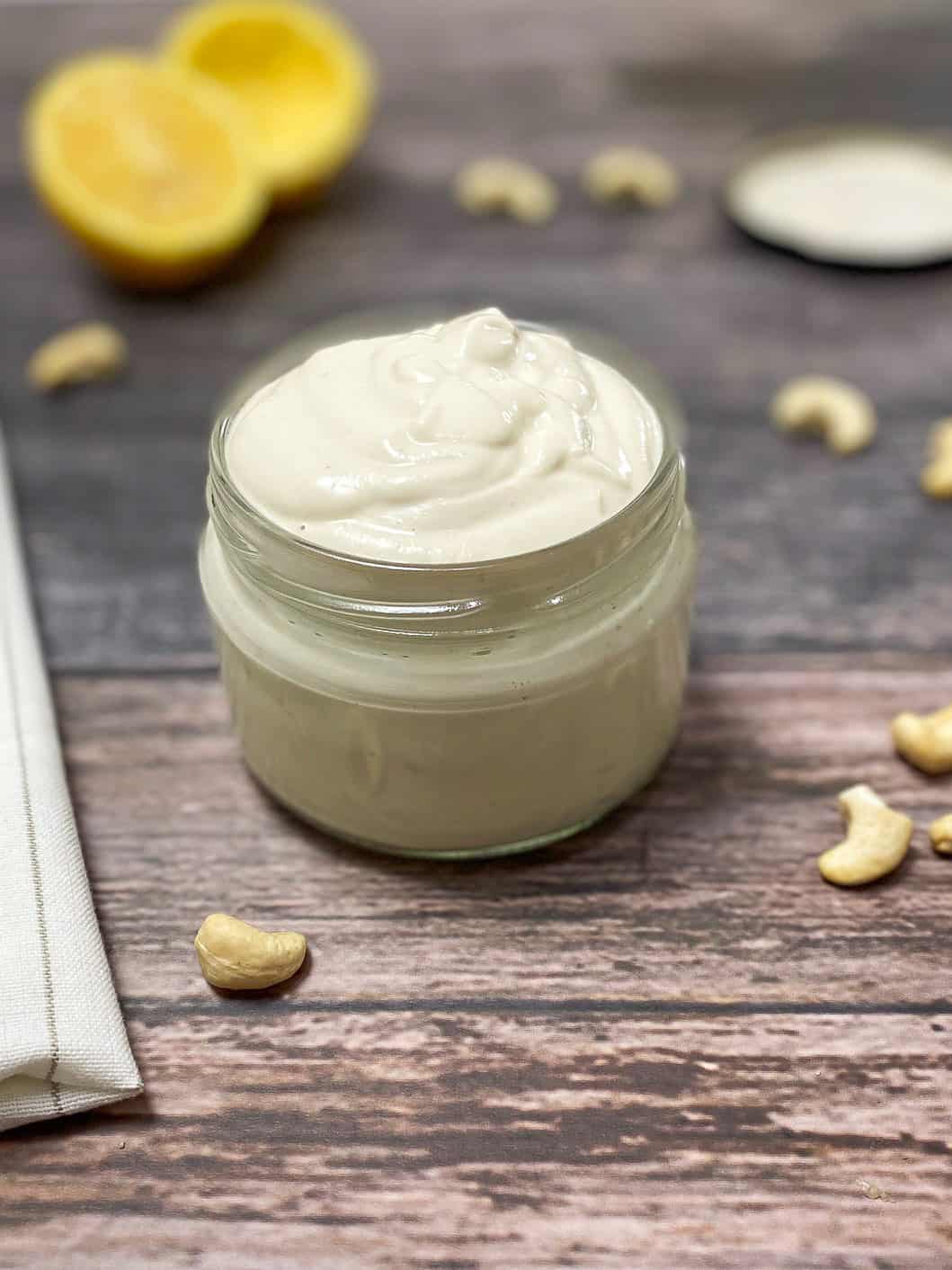 vegan sour cream in jar with lemon in background