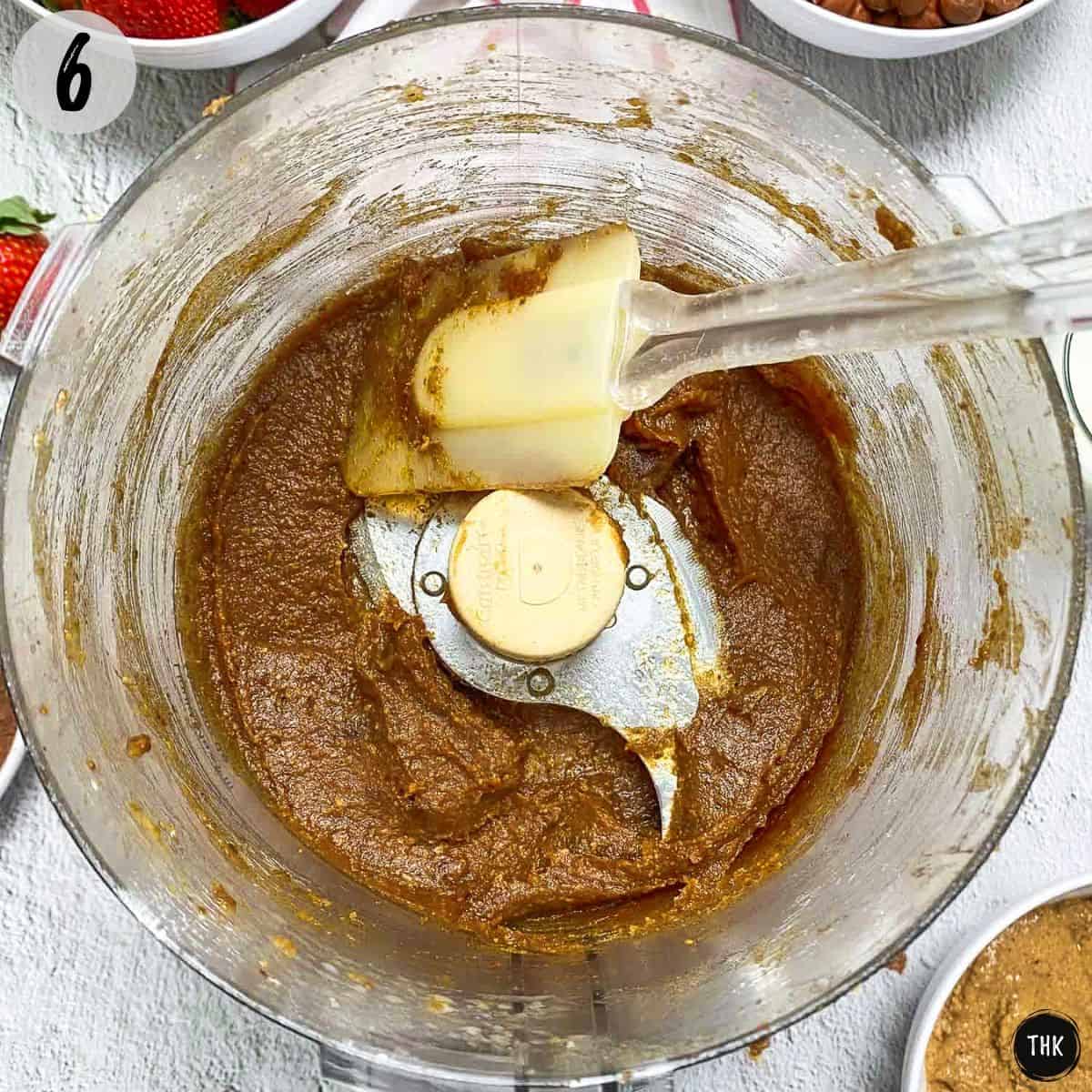 Pureed date paste inside food processor bowl.