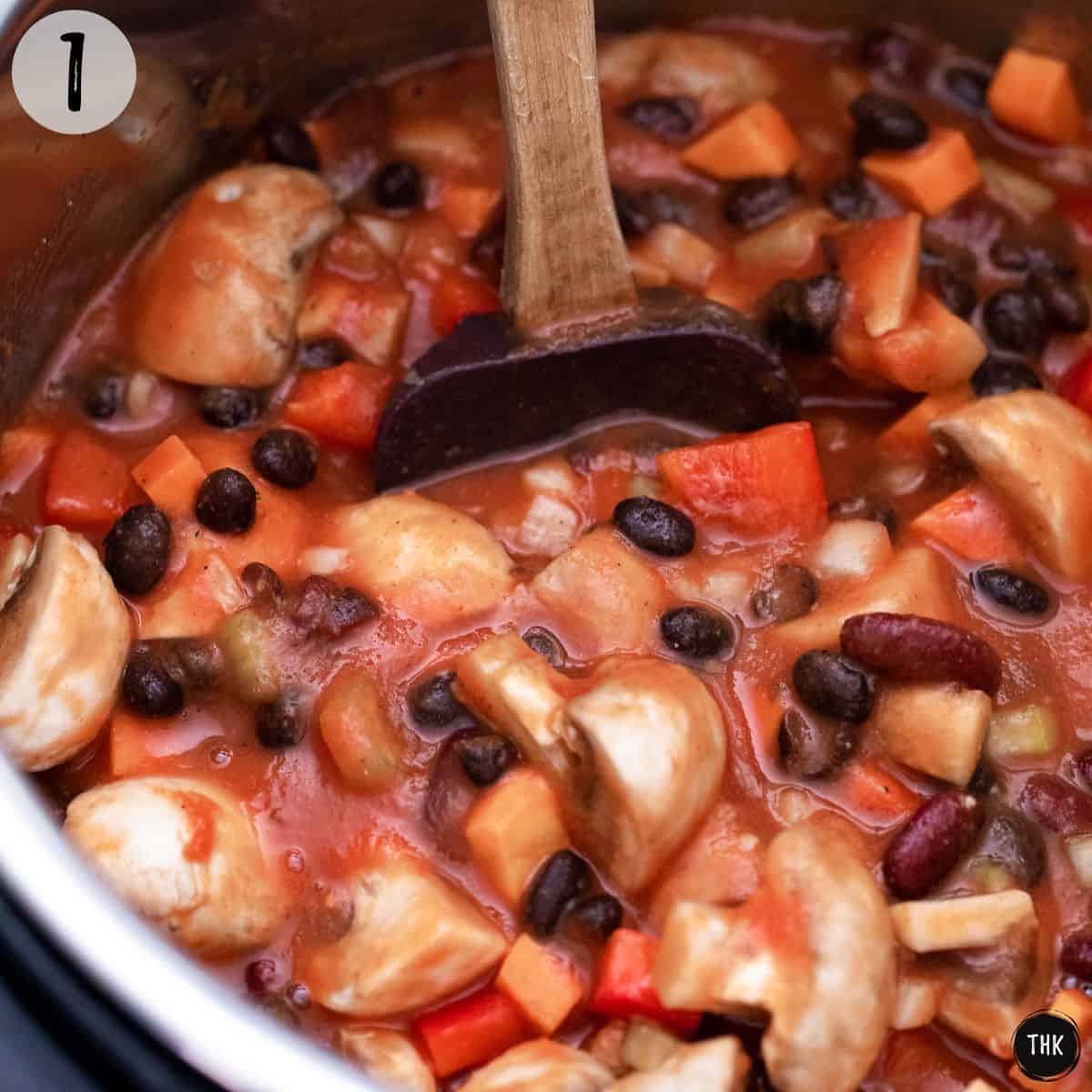 Beans and veggies with tomato sauce inside Instant Pot.