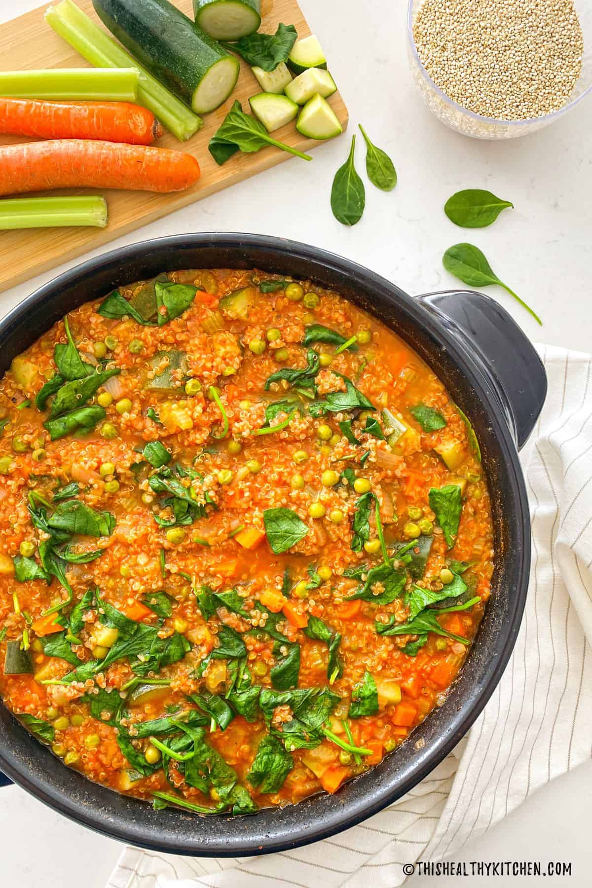 Dutch oven with vegetable and quinoa soup inside.