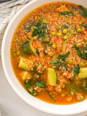 Bowl of soup with quinoa and vegetables.