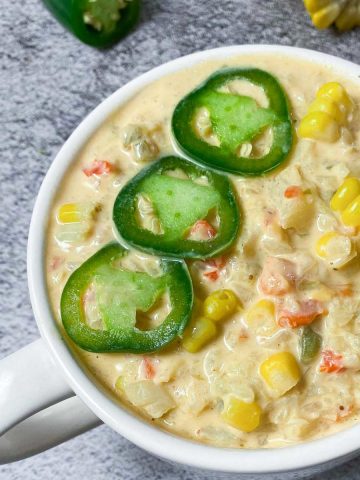 white soup mug with vegan jalapeno popper soup inside