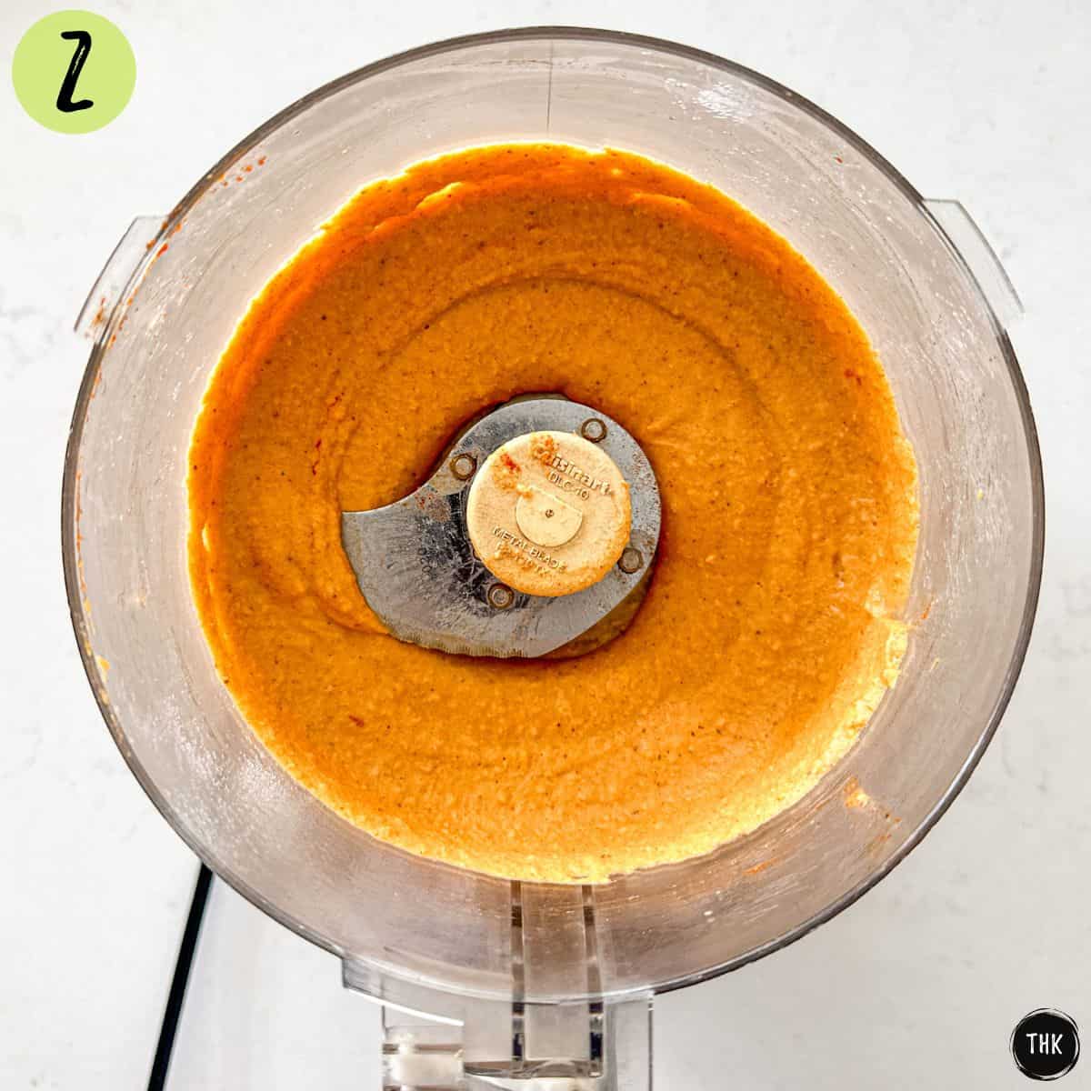 Orange dip inside food processor.