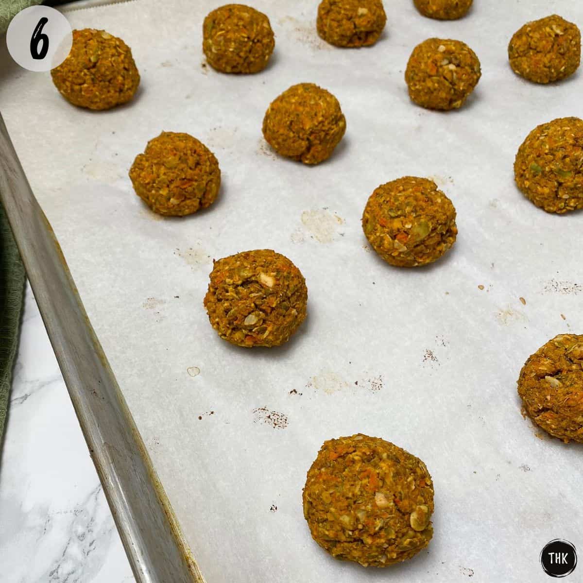 Baked vegan meatballs on large tray.