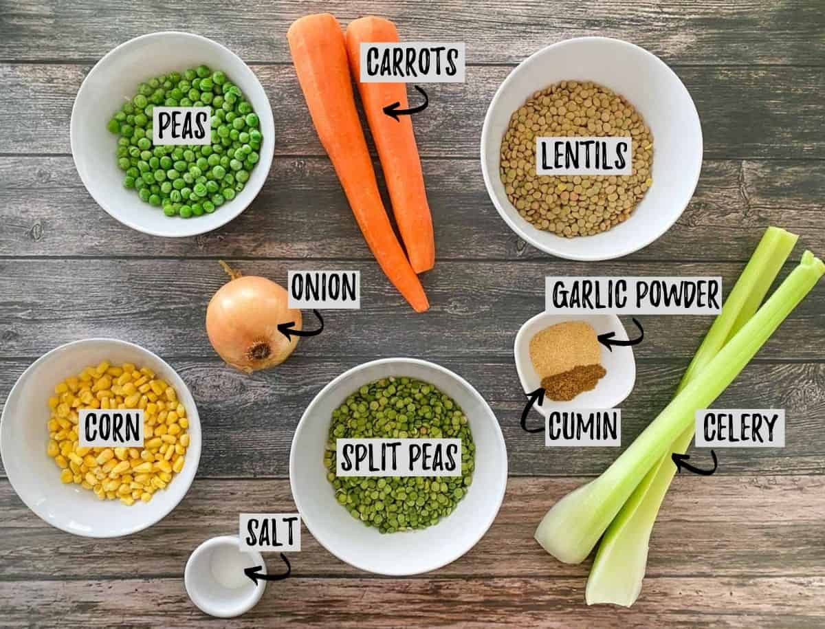 Ingredients to make lentil and split pea soup in bowls on brown deck.