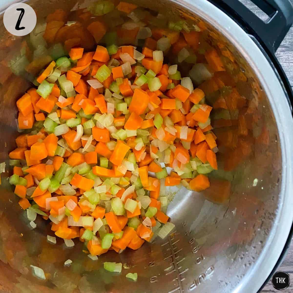 Sauteed chopped onion, carrots and celery inside Instant Pot.