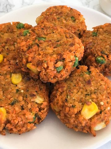 Veggie Lentil Nuggets on plate with tray of nuggets behind