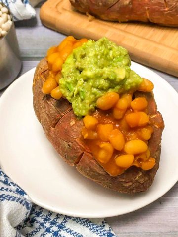 Loaded sweet potato with baked beans and guacamole.