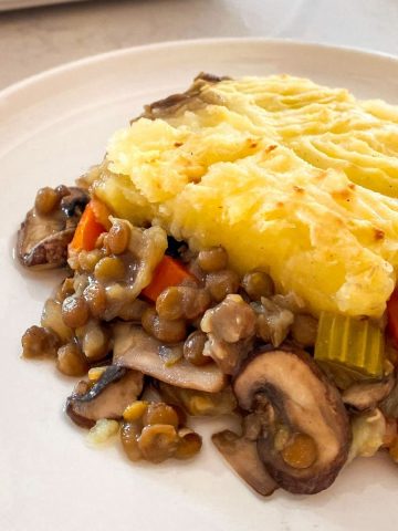 Slice of vegan shepherd's pie on white plate.