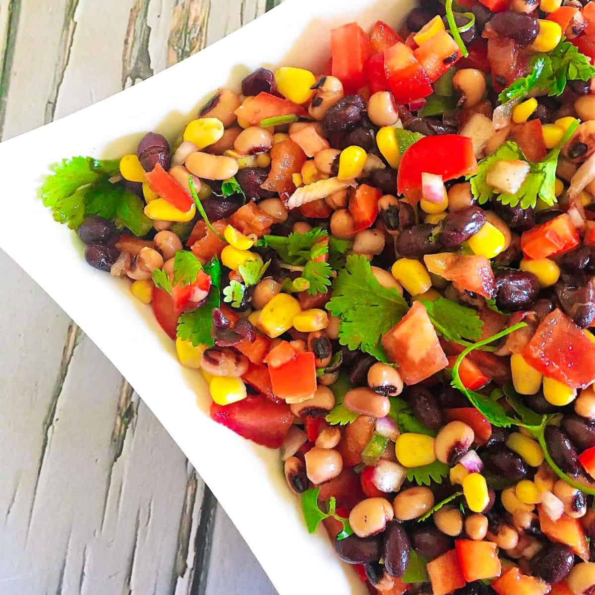 Cowboy caviar in white square dish.