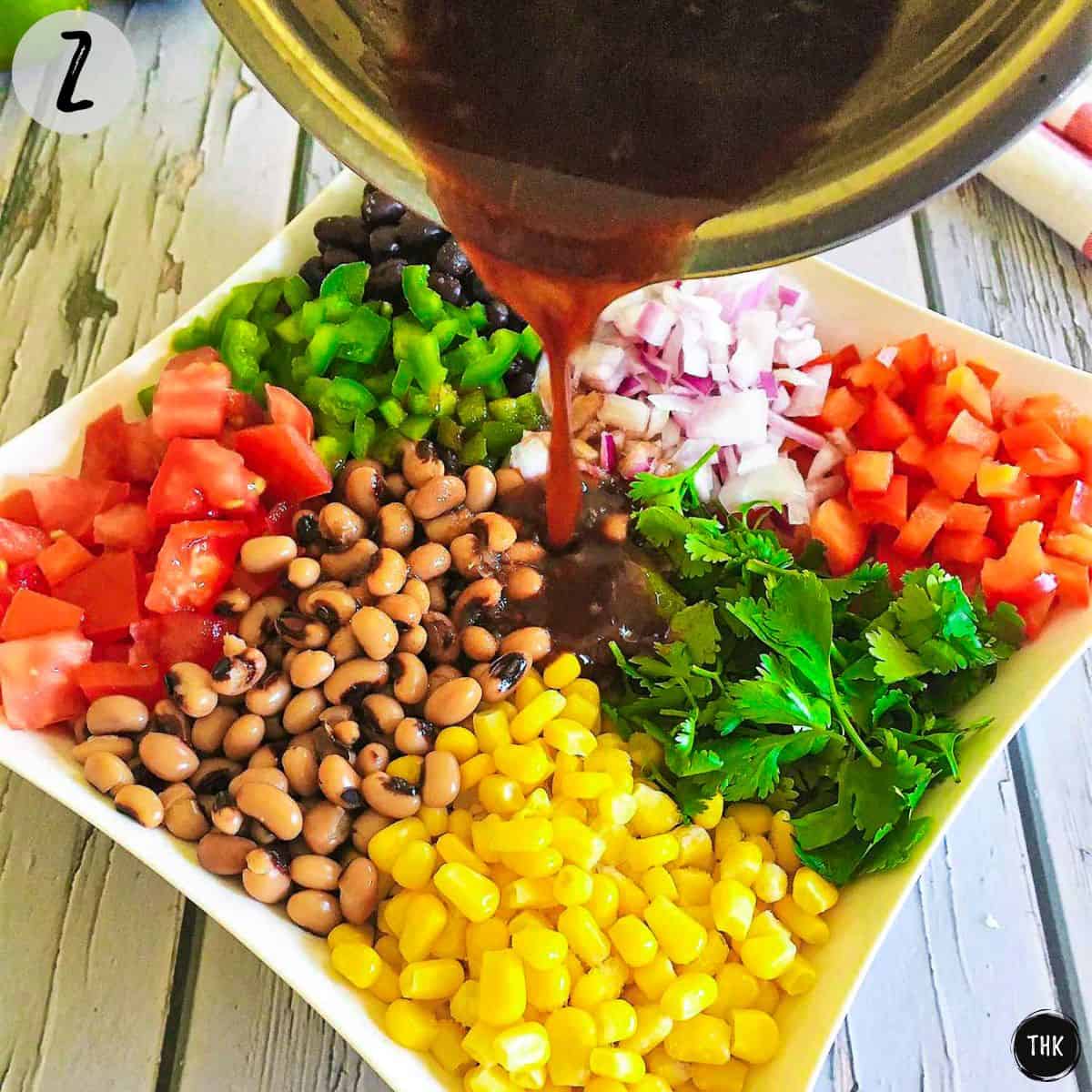 Dressing pouring on top of salad.
